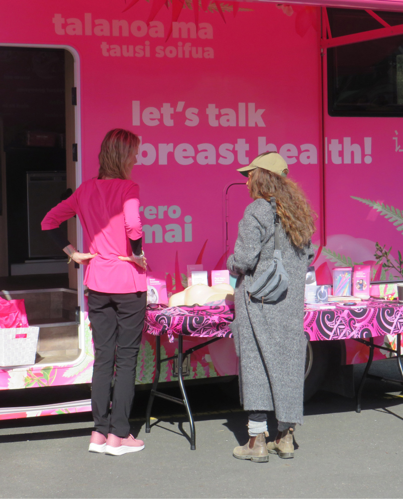 Community Breast Health Education, Kelle, talking to woman outside the Pink Campervan in Waiheke